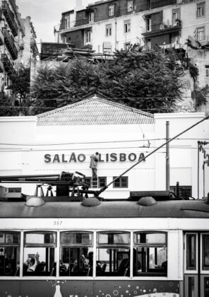 Black and white photograph by Nuno Félix da Costa, of the facade of the Salão Lisboa cinema in Martim Moniz with a tram in front